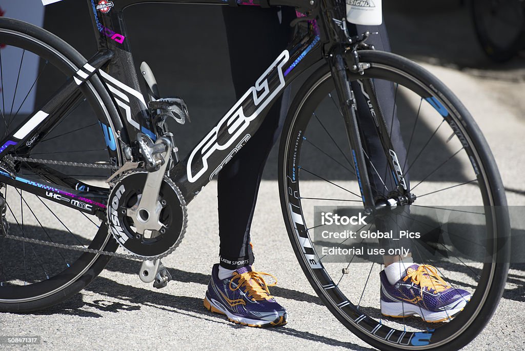 Ironman BRAZIL 2014 Florianópolis, Santa Catarina, Brasil - May 24, 2014: Ironman racing bicycle close-up at the check-in start point with a female competitor in the background during the Ironman competition. 2014 Stock Photo