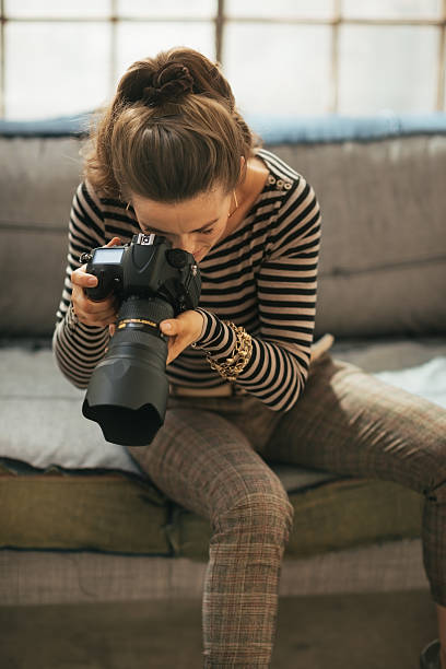 istock young woman using modern dslr photo camera 508471425