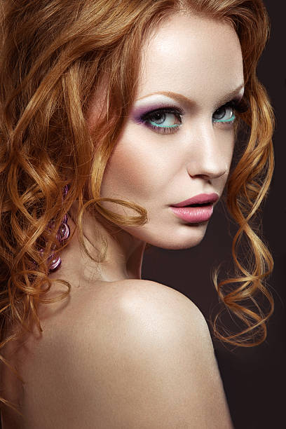 istock Beautiful red-haired girl with bright makeup and curls. 508472399
