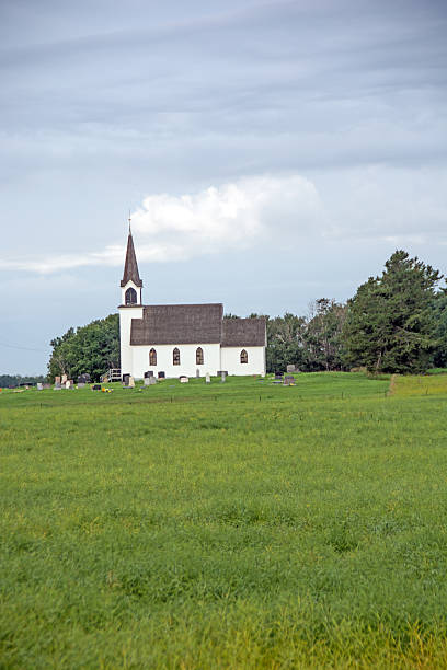 istock Old white rural church in a open field 508473097