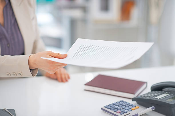 istock closeup on business woman giving document 508473557