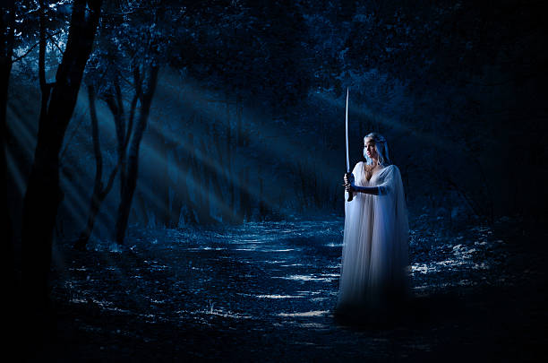 istock Elven girl with sword in night forest 508481648