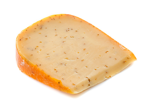 Gouda cheese with caraway in front of white background