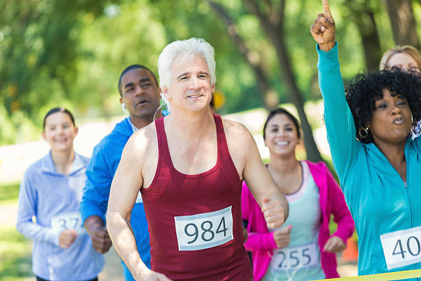 istock Senior man running in 5k nears finish line 508484344