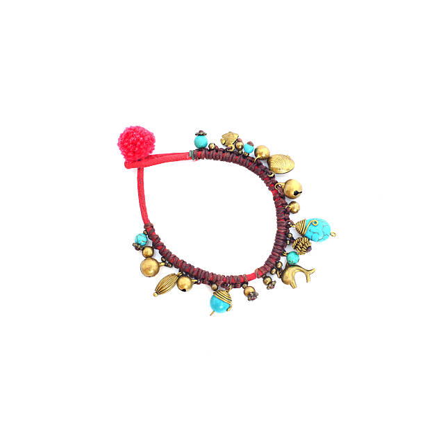 blue braided red bracelet on white background. brass