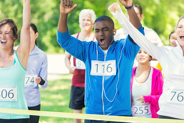 istock Diverse group of runners celebrate at finish line 508484746