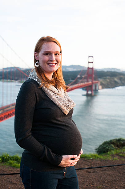 pregnant woman at  the Golden Gate Bridge stock photo