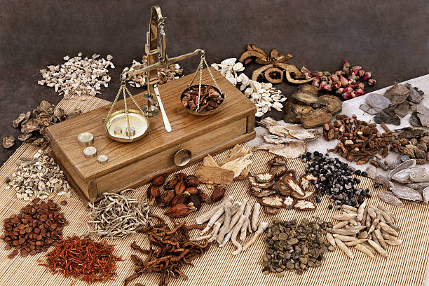 Chinese Herb Ingredients Traditional chinese herbal medicine selection with herb ingredients and old scales. chinese herbal medicine stock pictures, royalty-free photos & images