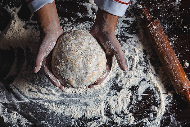 istock Hands with flour on dark wooden background close-up 508490030