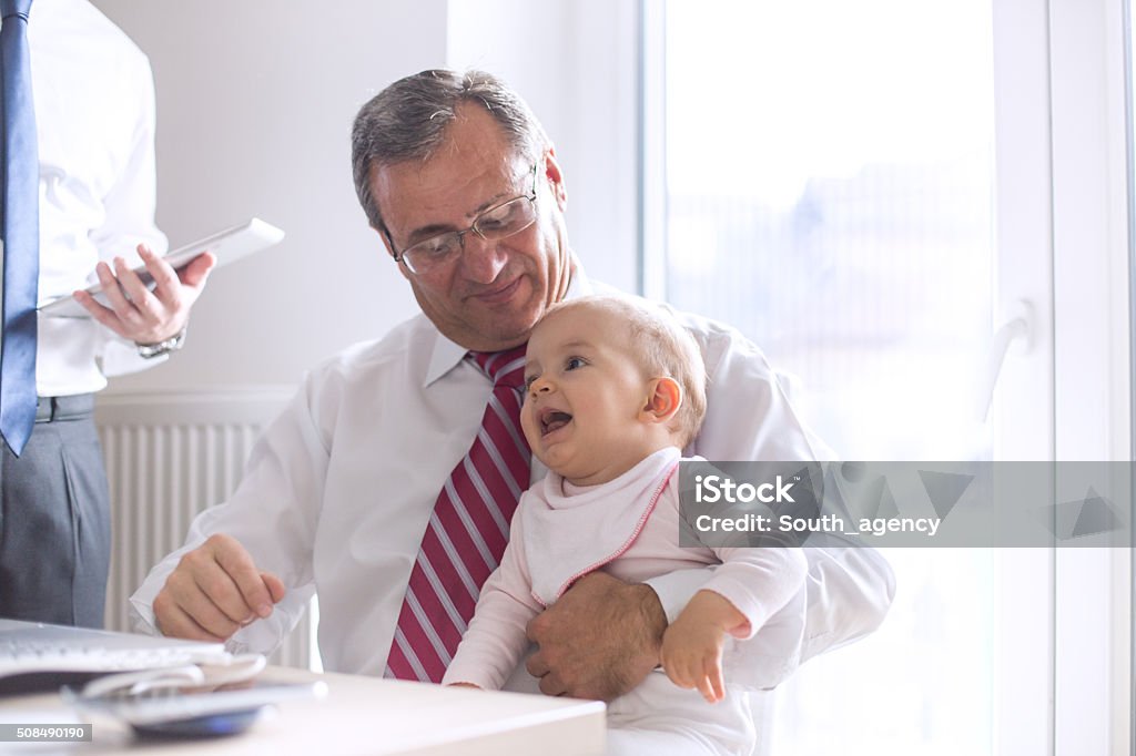 Baby and grandfather Grandfather holding baby at the office 30-39 Years Stock Photo
