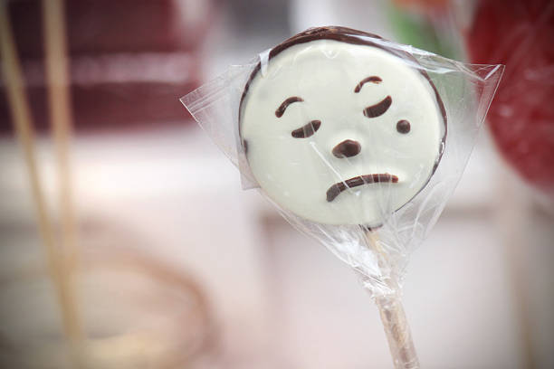 Sad-face harlequin clown lollipop.