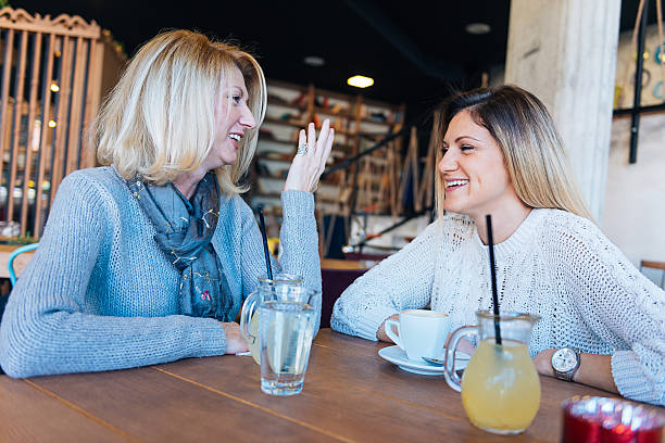 istock Mature and young woman having coffee time in modern cafe 508491406