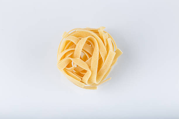 istock Mound of pasta on a white background close-up macro 508491778