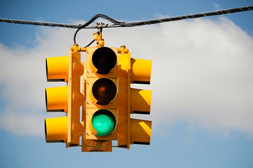 Green light on a traffic signal at an intersection.