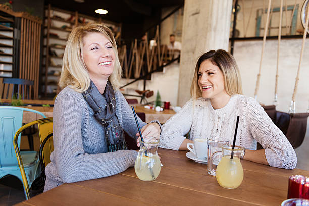 istock Mature and young woman having coffee time in modern cafe 508495586