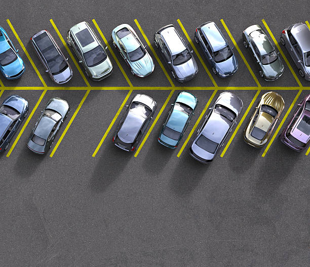 istock parked cars with one spot free 508496292