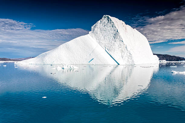 An iceberg is a large piece of freshwater ice that has broken off a glacier or an ice shelf and is floating freely in open water. It may subsequently become frozen into pack ice (one form of sea ice). As it drifts into shallower waters, it may come into contact with the seabed, a process referred to as seabed gouging by ice...Because the density of pure ice is about 920 kg/m³, and that of sea water about 1025 kg/m³, typically only one-ninth of the volume of an iceberg is above water. The shape of the underwater portion can be difficult to judge by looking at the portion above the surface.