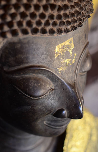 istock Smiling buddha statue with closed eyes. 508497896