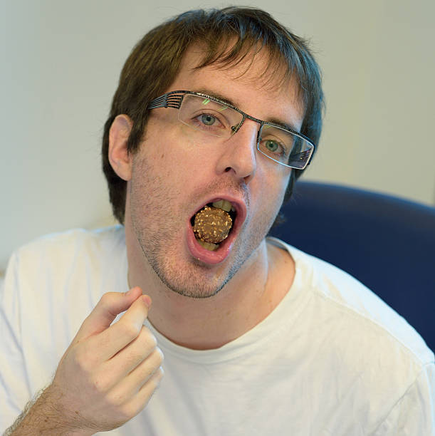 istock Man eating sweet chocolate 508510265