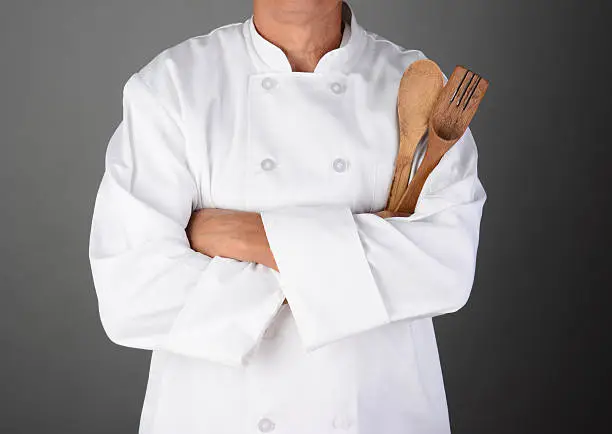 Photo of Chef Holding Wood Utensils