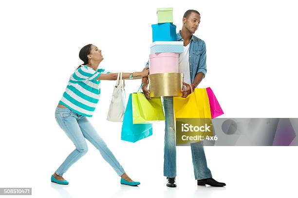 Girlfriend Pulling Her Boyfriend Stock Photo - Download Image Now - Bag, Carrying, Men