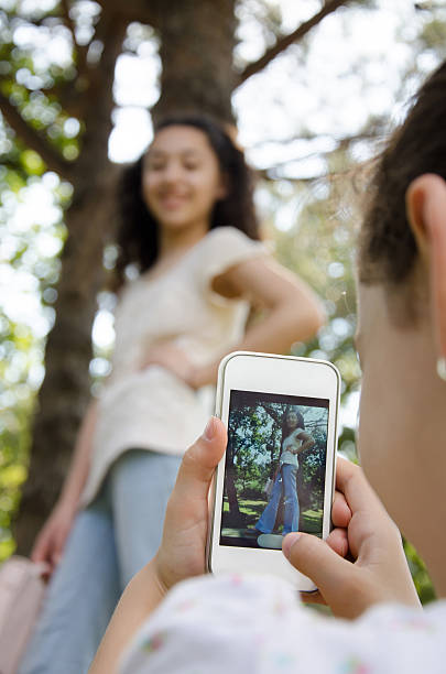 istock Sisters taking pictures with their smart phones 508510723