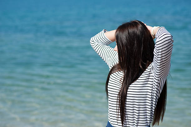 istock beautiful brunette woman on the beach 508511003