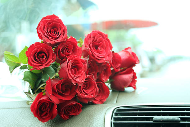 istock Red roses bouquet on car console 508511477
