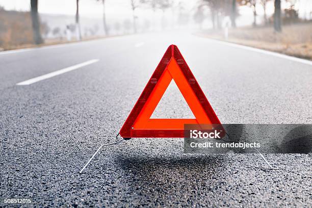 Bad Weather Driving Warning Triangle On A Misty Road Stock Photo - Download Image Now