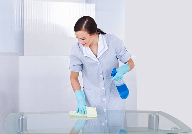 istock Happy Maid Cleaning Glass Table 508512071