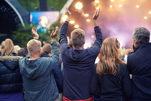 Adoring audience A crowd dancing at an outdoor music event singer back stock pictures, royalty-free photos & images