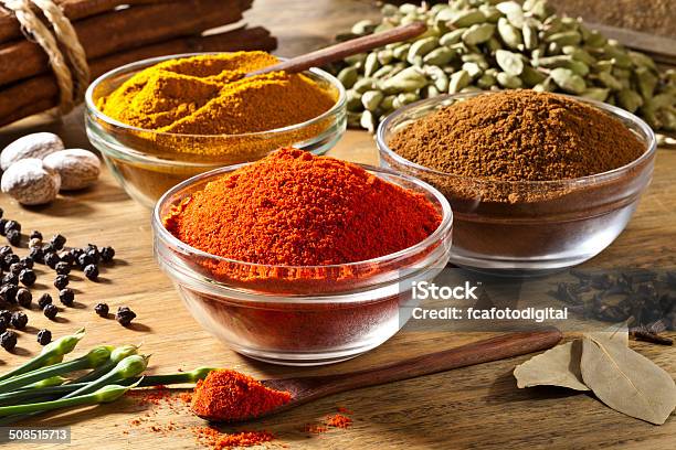 Three Bowls Filled With Spices On Rustic Wood Table Stock Photo - Download Image Now