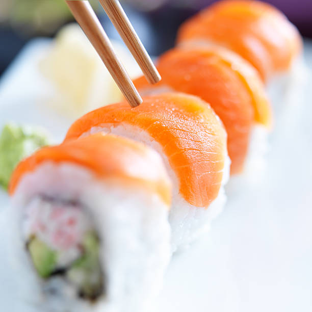 istock eating sushi with chopsticks 508516443