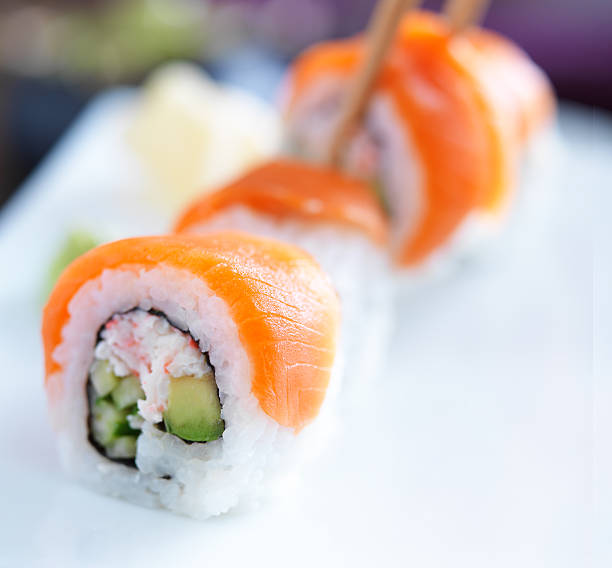 istock picking up a salmon sushi 508516453