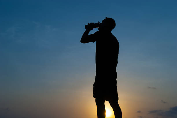 istock The man drinks from a bottle at dawn 508517574