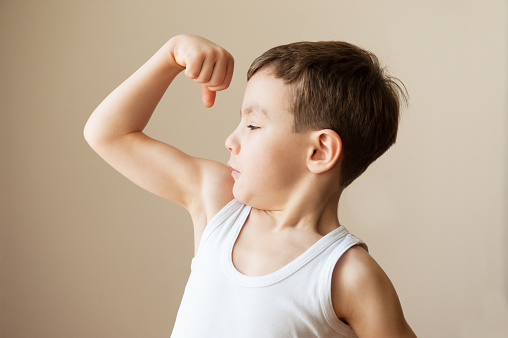 boy showing muscular biceps training athlete sports