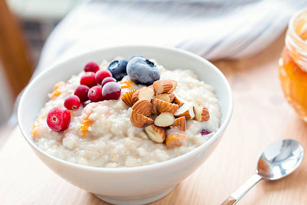 istock Oatmeal porridge with berries and nuts in bowl 508521748