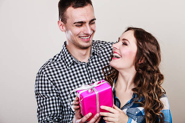 istock happy romantic couple with gift 508523152