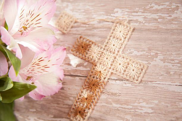 Wooden cross and bible on the table.