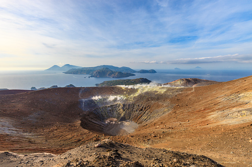 Fumaroles on the Gran Cratere della Fossa, the main crater of Vulcano, on the island of the same name. Aeolian Islands in the background. Sicily, Italy