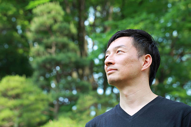 profile of middle aged Japanese man outdoors