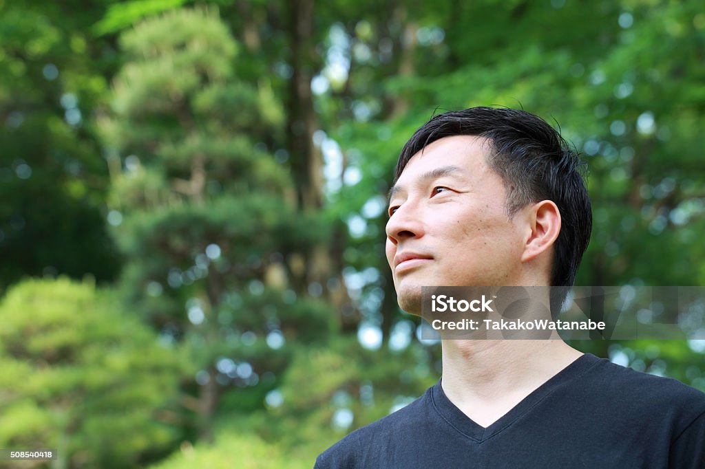 profile of middle aged Asian man profile of middle aged Japanese man outdoors Men Stock Photo