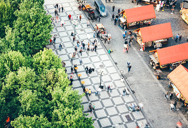 Prague, Czech Republic - April 24, 2014: Lively atmosphere in Prague's Old Town Square. Tourists are sightseeing and buying souvenirs on the market. Market consist of decorated wooden huts selling Czech products.