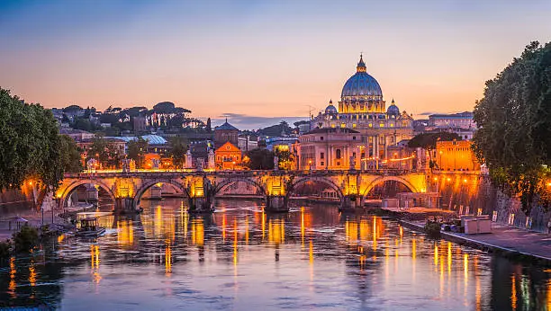 Photo of Rome sunset over Tiber and St Peters Basilica Vatican Italy