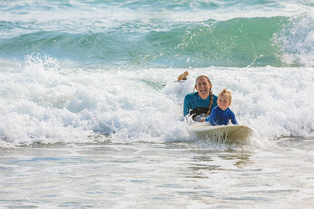 istock Mother Taking Her Young Child Surfing at the Beach 508541016