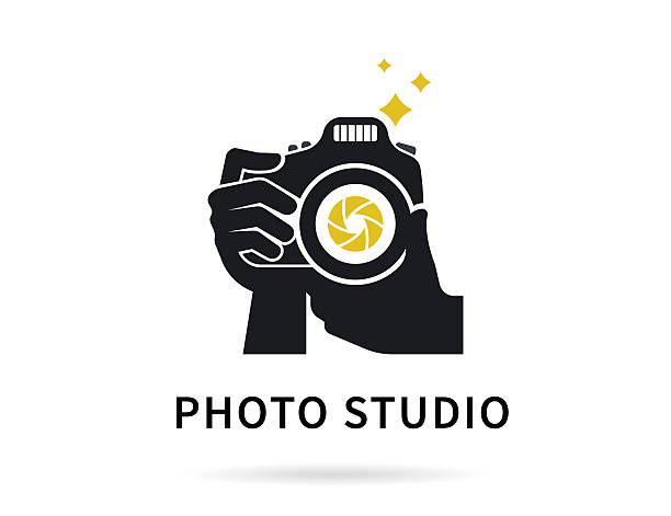 Photographer hands with camera flat illustration for icon or logo Photographer hands with camera icon or logo template. Flat illustration of lens camera shooting macro image with flash and text ideal photo camera flash photos stock illustrations