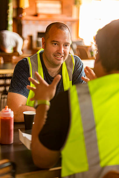 istock Workmen Relaxing With Beer After Work in High Visibility Clothes 508542816