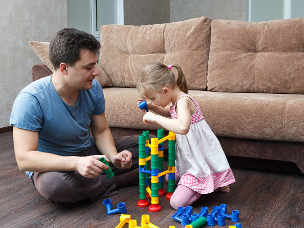 istock father and daughter build ball slide tower 508543006