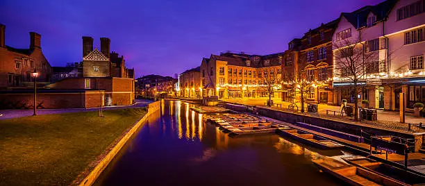 Early morning panoranic of historic Quayside river frontage with punt station in central Cambridge opposite Magdalene College