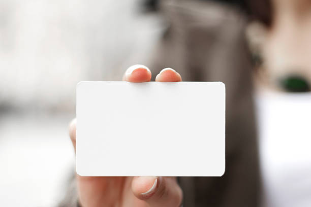 istock Young women holding a blank card in hands 508544232